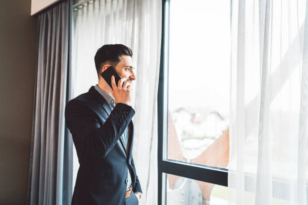 istock A young businessman making a phone call near a big window 1155043254