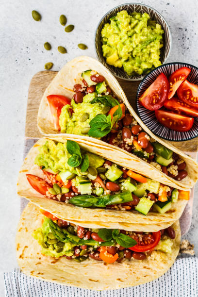 vegan tortillas with quinoa, asparagus, beans, vegetables and guacamole. - guacamole avocado mexican culture food imagens e fotografias de stock