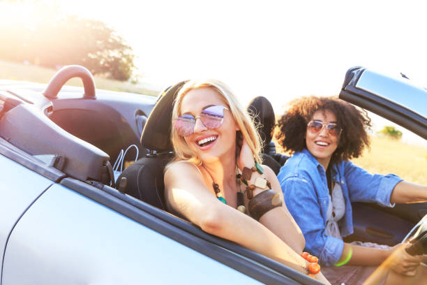 istock Girlfriends having fun on road trip 1155046422