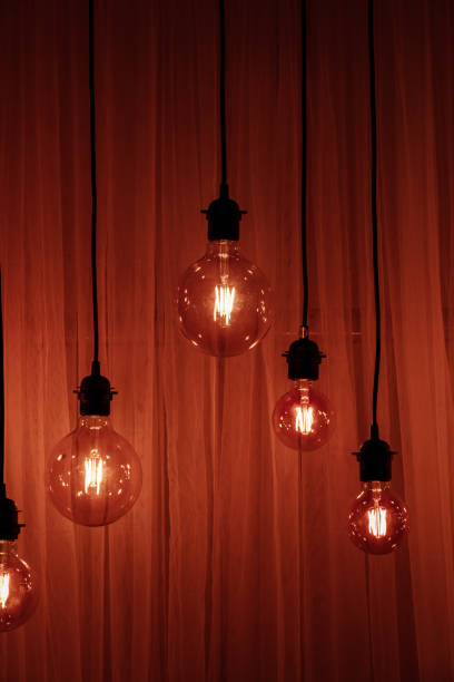 istock Light bulb on a dark background. Space for your task or message. Garland Light Bulb 1155056837
