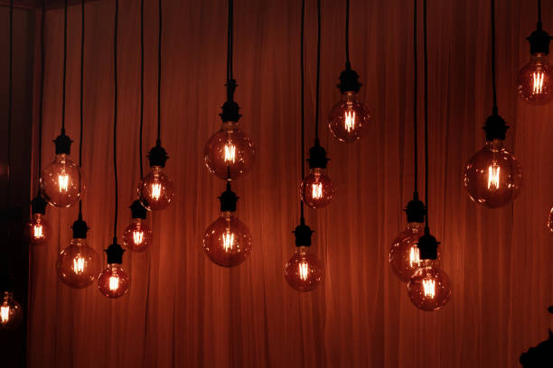 istock Light bulb on a dark background. Space for your task or message. Garland Light Bulb 1155057256