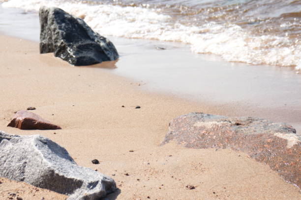 istock coastline with sand and stones washed by the waves 1155058273