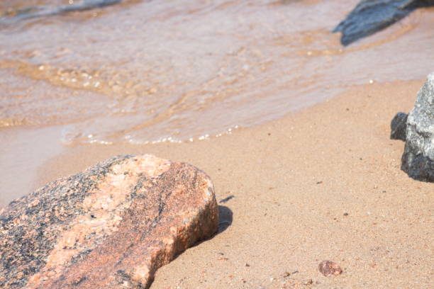 istock coastline with sand and stones washed by the waves 1155058290