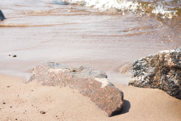 istock coastline with sand and stones washed by the waves 1155058352