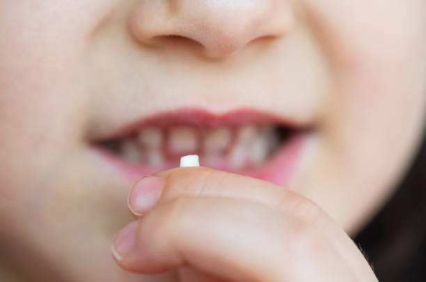 istock Girl with Milk Tooth 1155060797