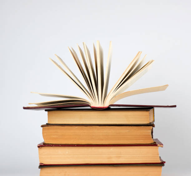 istock stack of books and an open book with yellow pages 1155061502