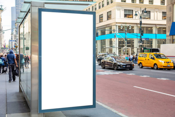 blank billboard at bus stop for advertising, new york city buildings and street background - bus stop imagens e fotografias de stock
