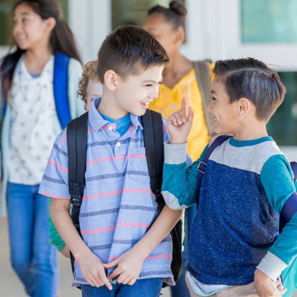 istock Schoolboy jokes with his best friend 1155064255