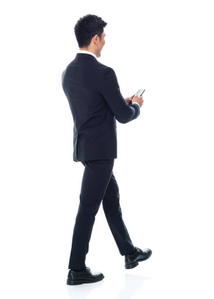 istock Attractive Asian businessman on white background - texting on phone 1155064267