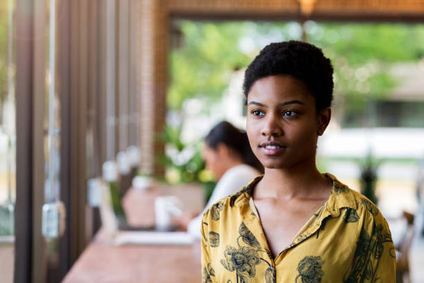 istock Young woman stops work in coffee shop to reflect 1155064273