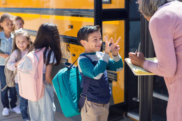 istock Schoolboy gestures his age to his new bus driver 1155064289