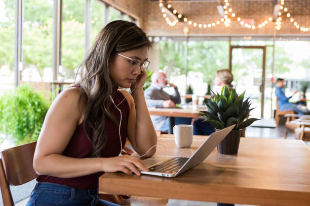 istock Hispanic American college student studies at coffee shop 1155064344