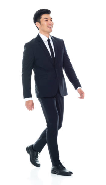 istock Attractive Asian businessman on white background - walking 1155064584