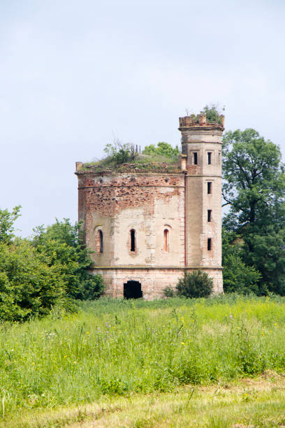 istock Small ruined abandoned castle overgrown in vegetation 1155065612