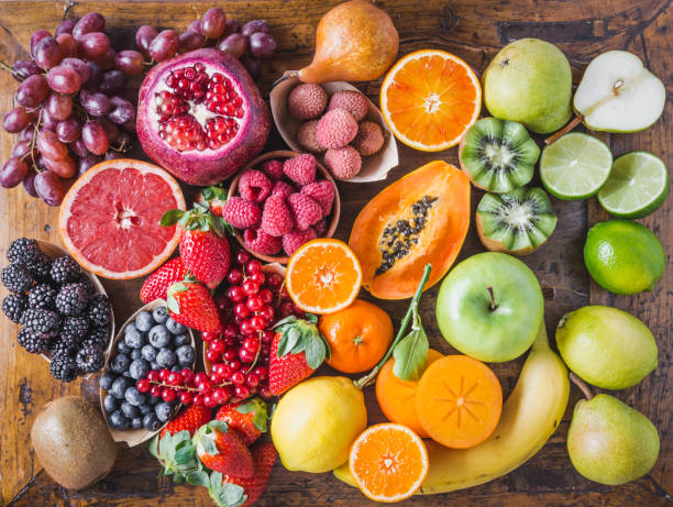 Fruits and berries rainbow top view.Natural vitamins and antioxidants food concept. Fruits and berries rainbow background top view on rustic wooden table.Natural vitamins and antioxidants food concept. perfect pear stock pictures, royalty-free photos & images