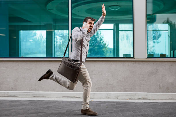 istock Businessman running and waving with hand 1155067895