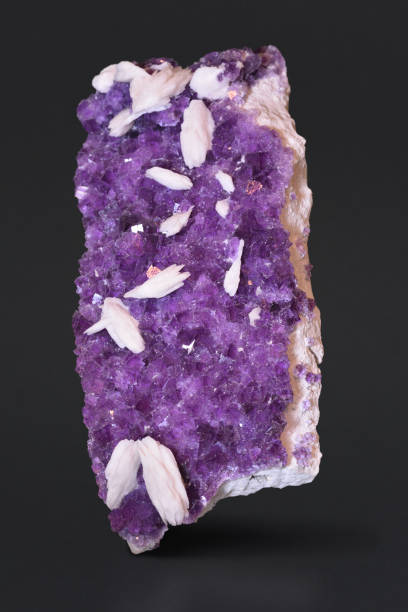 istock Purple fluorite with white barite crystals. 1155068122
