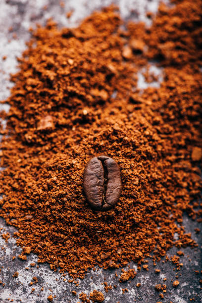 istock Coffee bean on heap of grinded coffee 1155070792