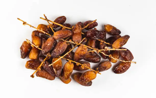 date palm fruit over white background