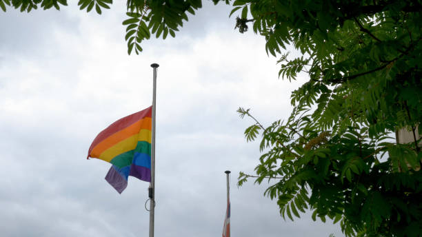 istock LGBT rainbow pride flag waving at wind on cloudy british sky background in northampton england 1155071149