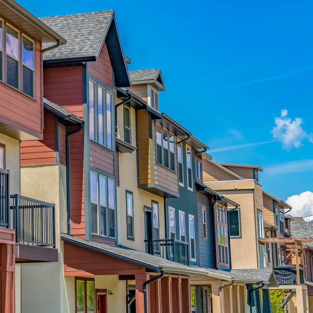 istock Square frame Bright sunlight beaming down on the row of houses with small balconies 1155076605