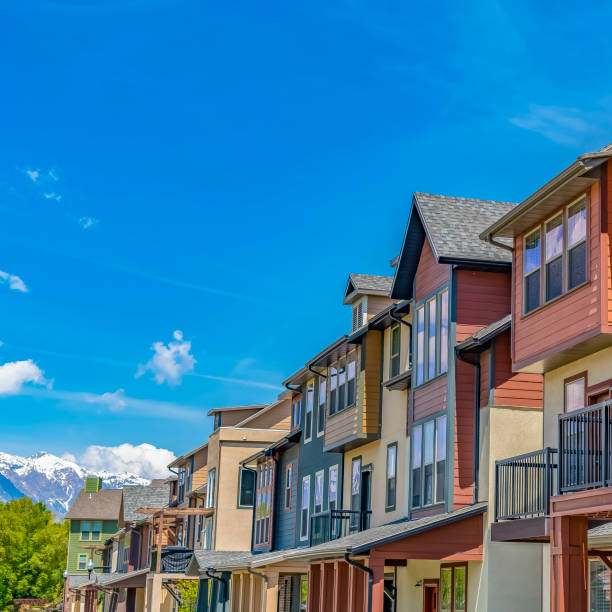 istock Square Bright sunlight beaming down on the row of houses with small balconies 1155076607