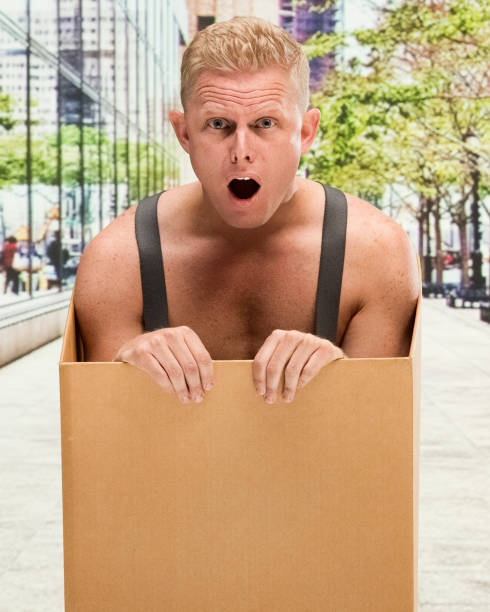 istock Poverty man in box shirtless is shocked 1155078862