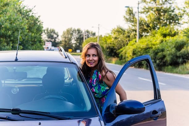 istock Woman Standing In front of Car 1155082679