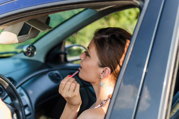 istock Attractive Young Woman Doing Makeup in the Car 1155084026