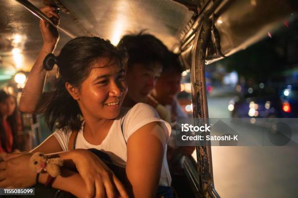 Multiethnic Asian Friends Riding Jeepney In Manila At Night Stock Photo - Download Image Now