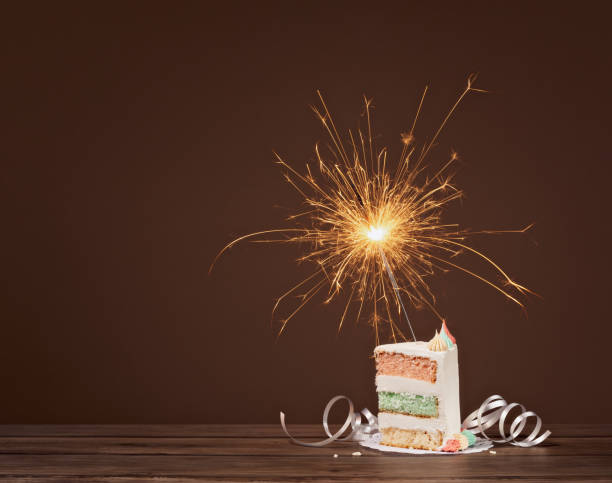 istock Slice of Birthday Cake with Sparkler 1155086939