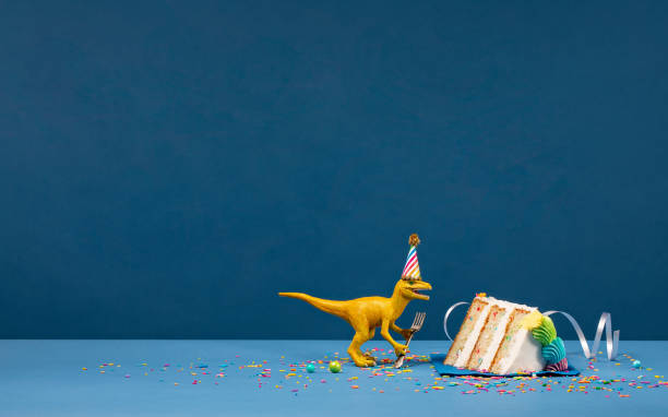 istock Dinosaur and slice of Birthday Cake 1155087783