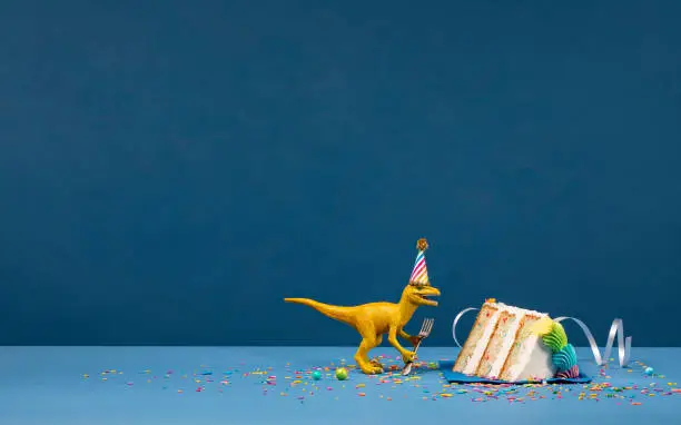 Photo of Dinosaur and slice of Birthday Cake