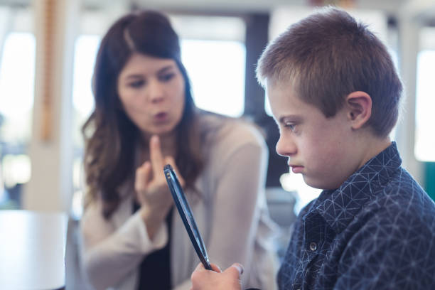 istock Speech therapist works with a young boy 1155090479