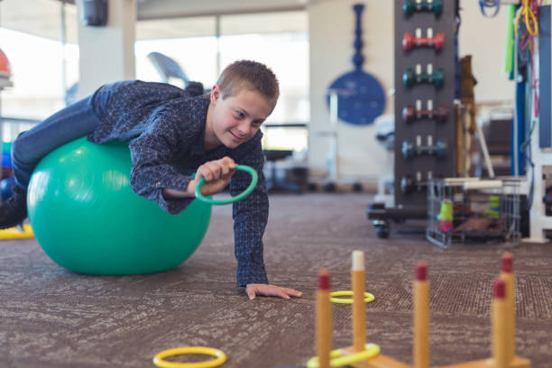 istock A boy does workouts with an occupational therapist at a physiotherapy clinic 1155090487