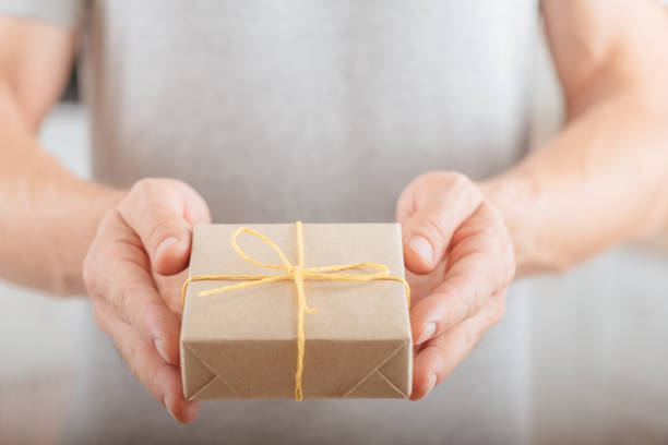 istock special day delivery service man hands gift box 1155091216