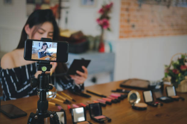 istock beauty blogger live broadcasting cosmetic makeup tutorial on social media. 1155091503