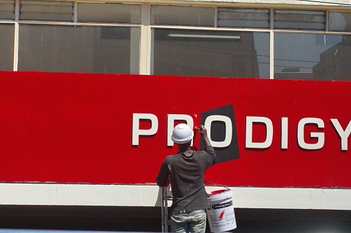 Man painting a sign in Johannesburg, South Africa