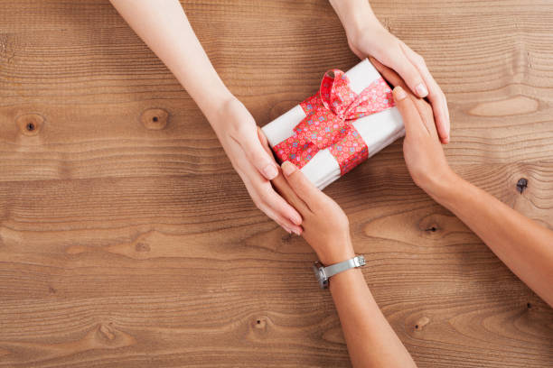 istock lesbian couple celebrating  with a gift 1155094068