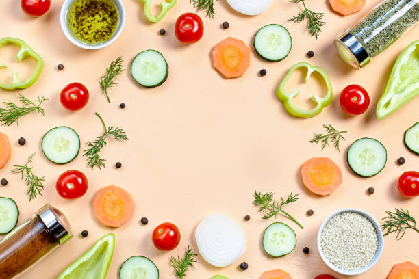 istock Salad ingredients layout. Food pattern with cherry tomatoes, cucumbers, greens, pepper and spices 1155097376