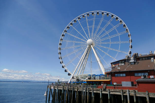 Seattle, WA, U.S.A., June 8, 2019 -- Looking at Pier 57 and the Great Wheel in Seattle, Washington.  The Seattle Great Wheel is a Ferris Wheel ride that opened in 2012.