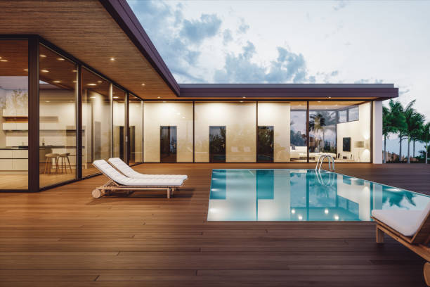 modern luxury house with private swimming pool at dusk - swimming pool luxury mansion holiday villa imagens e fotografias de stock