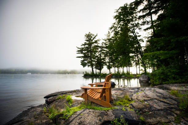 istock Adirondack chairs on a misty lake 1155107765