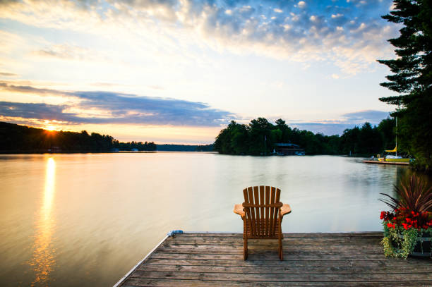 istock Adirondack chair on a wooden dock at sunrise 1155108547