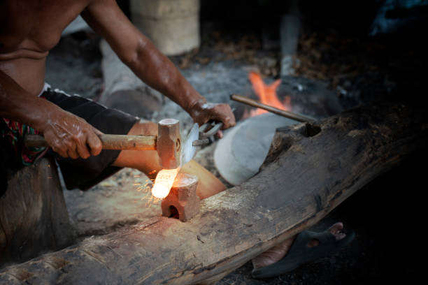 istock Blacksmith manually forging the molten metal on the anvil 1155112741