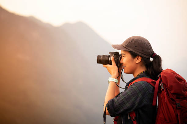 istock Backpacker woman take photo on peak mountain 1155112783