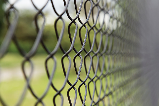 Metal grid with soft background, close up