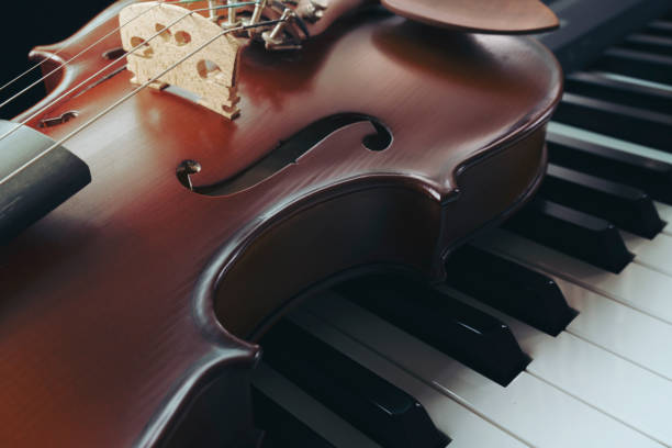 tastiera per pianoforte con violino, vista dall'alto - piano piano key orchestra close up foto e immagini stock