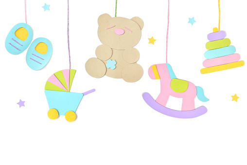 Baby toys hanging paper cut on white background