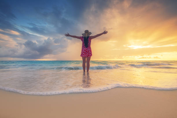 Free happy woman enjoying tropical Caribbean island beach, Dominican Republic. Summer vacation and healthy living concept. Free happy woman enjoying tropical Caribbean island beach, Dominican Republic. Summer vacation and healthy living concept. punta cana stock pictures, royalty-free photos & images